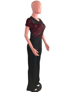 Detailed close-up of dark red sequins and black mesh patchwork on evening jumpsuit