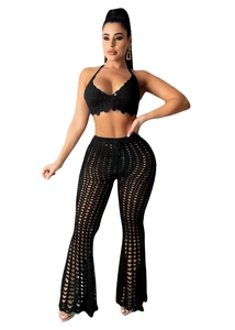 Detail of black crochet two-piece set featuring hollow geometric knit textures for beachwear