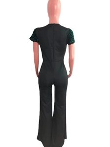Detail view of deep green sequin sleeve and back zipper of the slim-fit jumpsuit
