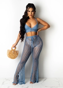 Detail of blue crochet two-piece set featuring hollow mesh knit pants and halter top