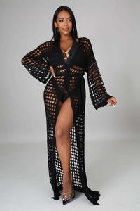 Macro detail of black knit honeycomb pattern on long sleeve beach cover-up with tie belt