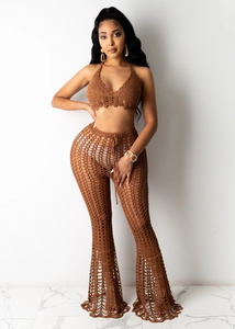 Detail of chocolate brown handmade crochet halter top and wide-leg mesh beach pants