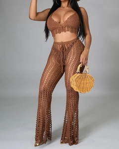 Detail of handmade brown crochet two-piece beach set featuring hollow knit texture