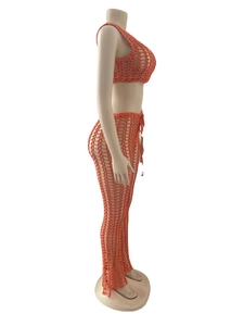 Detail of orange crochet two-piece set featuring large mesh hollow knit and high waist tie design