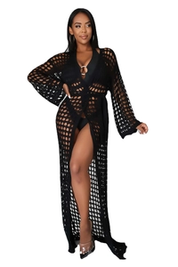 Detail of black crochet knit beach cover-up featuring intricate hollow-out floral patterns