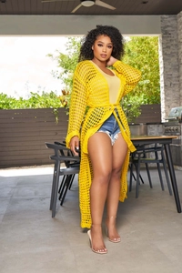 Detail of yellow knit beach cover-up featuring intricate honeycomb crochet and belted waist
