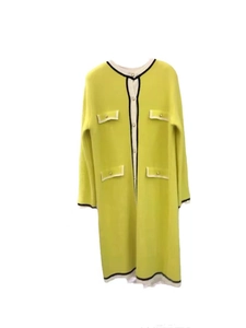 Detailed macro view of lime green French style knit dress with black and white trim borders