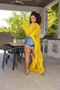 Detail of yellow hollow knit cardigan beach cover-up with long sleeves for women