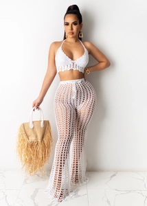 Detailed close-up of white crochet halter crop top and matching mesh wide-leg pants