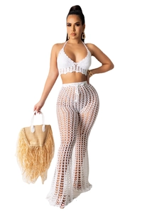 Detail of white handmade crochet two-piece set featuring hollow-out knit beach style