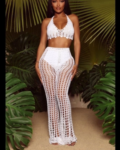 Close-up of white crochet texture and hollow knit pattern on two-piece beach set