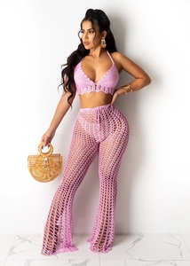 Detailed crochet texture of this two-piece hollow knit beach set in vibrant pink-purple