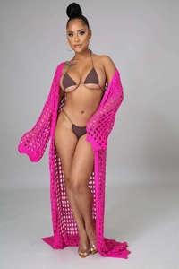 Close-up of rose pink crochet knit beach cover-up with detailed hollow mesh texture
