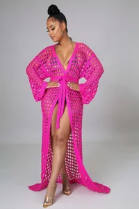Detail of rose pink open-knit beach cover-up with geometric crochet texture and lace-up waist
