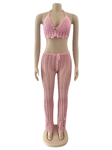 Detail of pink hand-crocheted hollow knit beach set with halter top and flared pants