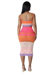 Detail of colorful striped knit two-piece set featuring hollow patterns on the skirt hem