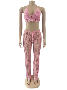 Detail of pink crochet two-piece beach set featuring hollow mesh knit and lace textures