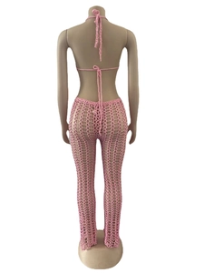Rear view of pink crochet beach set showing lace-up bikini top and hollow mesh pants