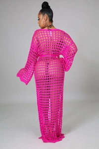 Detailed macro view of vibrant fuchsia crochet knit fabric with hollow geometric mesh pattern