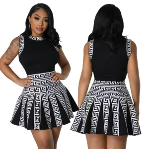 Women's sleeveless pleated dress featuring Greek key pattern on collar and hem