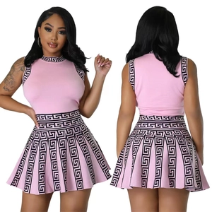 Pink sleeveless knit two-piece set with Greek key patterns on the top and pleated skirt
