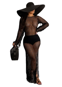 Detail of black crochet long sleeve beach dress with hollow knit pattern and tassels