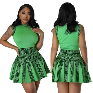 Two-piece green knit set with sleeveless top and pleated skirt featuring Greek patterns