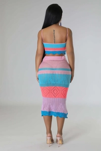 Close-up of colorful striped knit fabric texture on a two-piece beach set with wave edges