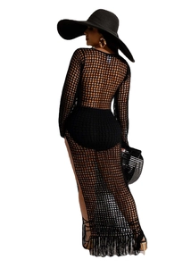 Back view of a black hollow knit crochet maxi dress with tassels and long sleeves for beachwear