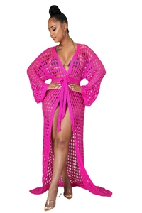 Detail of hot pink crochet long beach cover-up featuring mesh knit and waist tie