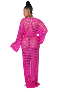 Macro view of hot pink crochet knit mesh fabric with detailed openwork pattern