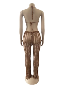 Detailed view of handmade crochet hollow knit pattern on two-piece brown beachwear set