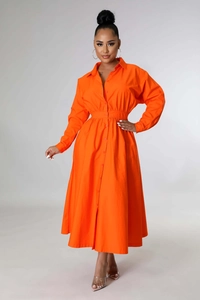 Détail des plis à la taille et de la fermeture à boutons sur cette robe chemise orange