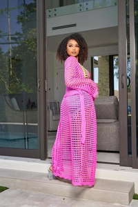 Detail of hot pink crochet long cardigan featuring hollow mesh knit and belted waist style