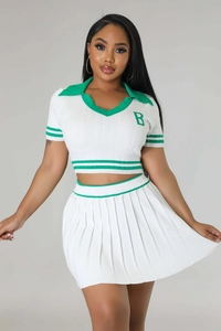 Close-up of white knitted crop top with green stripes and embroidered letter B