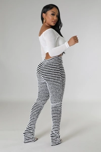 Women off-shoulder long sleeve top with high-waisted black and white striped flared pants