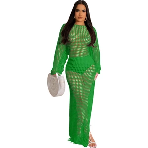 Detail of bright green crochet mesh dress featuring intricate tassels on sleeves and hem