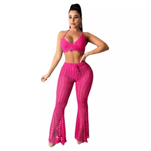 Hot pink handmade crochet two-piece set with halter bra top and hollow out flared pants