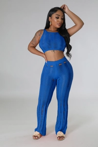 Detail of blue knitted two-piece set featuring hollow-out textures and ripped waist design