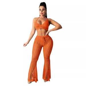 Orange crochet two-piece set featuring halter crop top and hollow out flare beach pants
