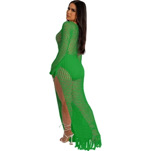 Detail view of bright green crochet dress featuring loose mesh texture and tassel fringe hem