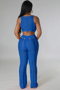 Detail of royal blue knitted two-piece set featuring hollow-out patterns and back tie closure