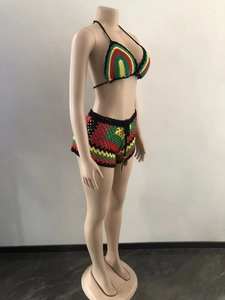 Detailed side view of handmade crochet bikini set with colorful reggae stripe patterns