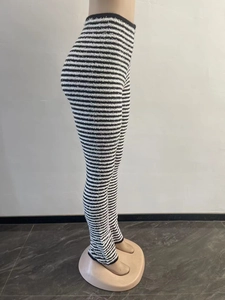 Detailed side view of high-waisted black and white striped fuzzy knit flared trousers