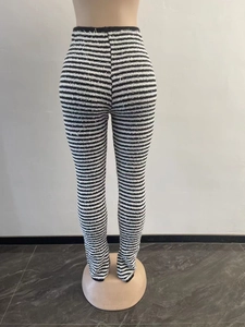 Close-up of high-waisted black and white striped knitted flared pants from the back view