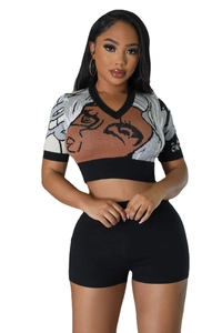 Close-up of knit crop top with abstract face jacquard and high waist shorts