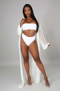 Detailed close-up of white crochet knit beach cover-up with intricate mesh texture