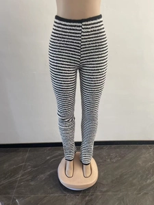 Detailed texture of black and white striped high waisted knitted wide leg flare trousers