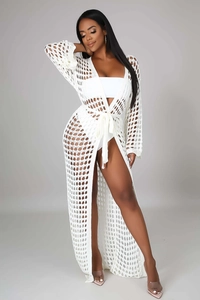 Detail of white crochet maxi beach cover-up showing intricate honeycomb knit texture