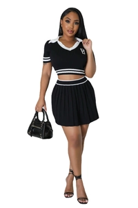 Close-up of contrast knit set featuring V-neck cropped top and pleated mini skirt